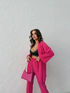 Three-piece women suit featuring rose pink cardigan, straight pants and black V-neck top