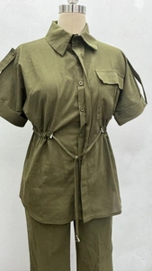 Detail of army green cargo set showing drawstring waist and button-down short sleeve shirt