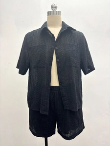 Close-up of black hollow eyelet embroidery on women's short sleeve shirt and shorts set
