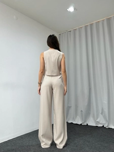 Back view of elegant beige two-piece set featuring sleeveless vest and wide leg pants