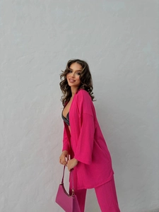 Detail view of the rose red textured two-piece lounge set with cardigan and trousers