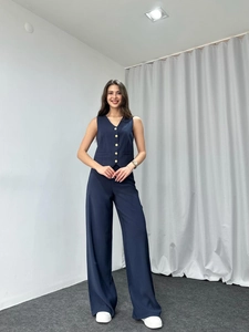 Detail of navy blue V-neck vest and wide-leg trousers suit set with gold buttons