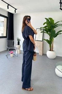 Detail of navy blue two-piece set featuring drawstring waist top and straight pants