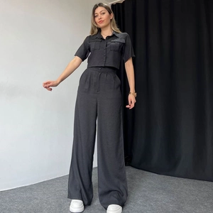 Women's black two-piece set featuring short sleeve button shirt and high waist wide leg pants