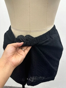Elastic waistband detail of black eyelet embroidery shorts showing stretch performance