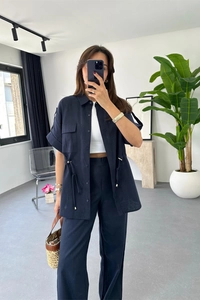 Navy blue two-piece set featuring drawstring short sleeve shirt and wide-leg trousers