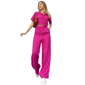Women's hot pink two-piece set featuring a short-sleeve button-up shirt and wide-leg pants