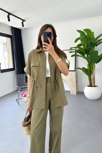 Detail of olive green two-piece linen set featuring drawstring waist and wide-leg trousers