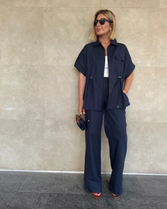 Navy blue two-piece set featuring short sleeve shirt with drawstring waist and wide-leg pants