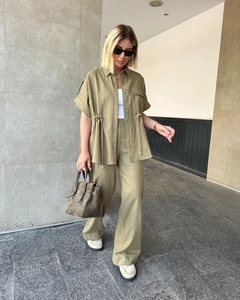 Detail of olive green two-piece set with drawstring short sleeve shirt and wide leg pants