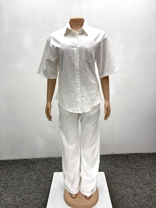 Detail of white two-piece set showing lightweight cotton linen texture and button shirt