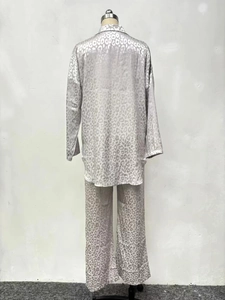 Detail showing high-quality leopard print satin fabric and stitching of the two-piece set