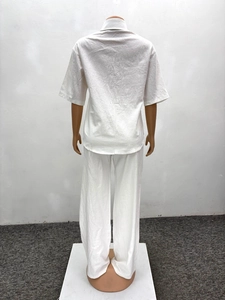 Rear view of white casual two-piece set featuring loose shirt and trousers on mannequin