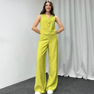 Women's 2-piece neon green vest and wide-leg trousers set in a minimalist studio setting