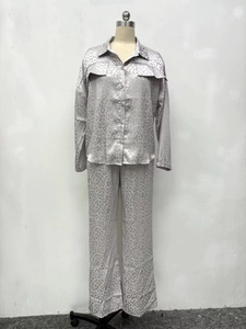 Detailed view of the leopard print satin fabric and button-down shirt pocket design