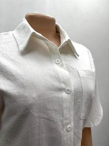 Close-up of white cotton linen short sleeve shirt with collar, pocket and buttons