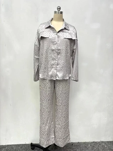 Detailed view of leopard print satin pajama set with long sleeves and buttons
