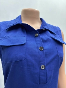 Detail of royal blue sleeveless cargo vest with turn-down collar and twin chest pockets