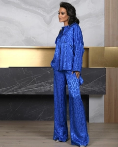 Close-up of deep blue satin two-piece set with leopard jacquard texture and silky shine