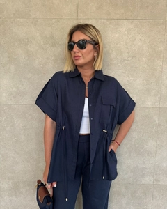 Detail of navy blue linen set showing adjustable drawstring waist and chest flap pockets