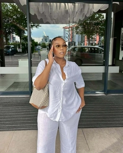 Minimalist white cotton linen two-piece set featuring loose shirt and wide-leg trousers