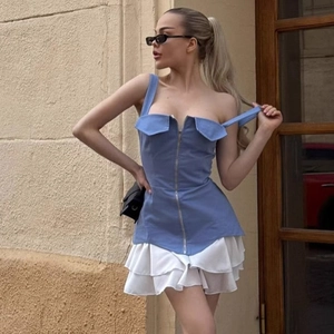 Detail of light blue zip-up camisole top with tiered white ruffled mini skirt