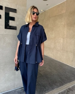 Detail of navy blue linen short-sleeve shirt with drawstring waist and cargo pockets