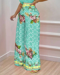 Détail du pantalon taille haute vert menthe à fleurs avec taille ondulée chic