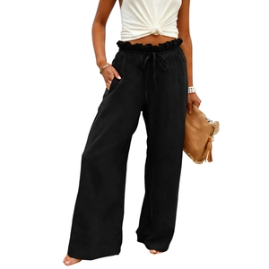 Detail of high waisted black wide leg pants with paperbag drawstring and side pockets