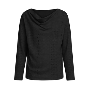 Detail of black cowl neck top featuring delicate hollow-out embroidery and loose fit