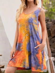 Detail of summer sleeveless tie-dye dress featuring side pockets and vibrant orange-purple patterns