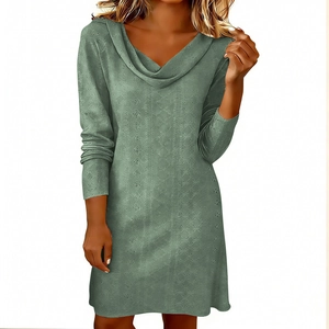 Detail of grey-green long sleeve dress featuring intricate eyelet hollow-out patterns