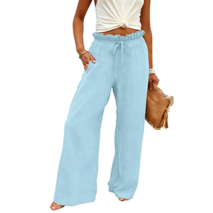 Detail of light blue high waisted linen pants featuring paper-bag waist and drawstring