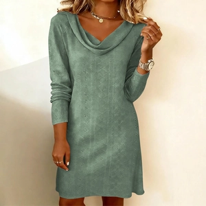 Close-up of sage green dress fabric featuring intricate hollow-out perforated vertical stripes