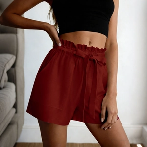 Detail of wine red paperbag waist shorts with adjustable drawstring and functional pockets