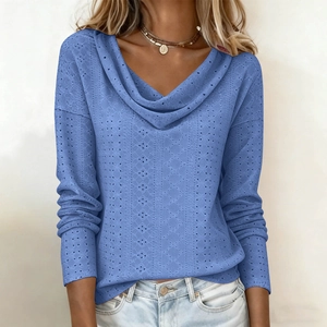 Detail of blue draped neck top featuring intricate hollow-out eyelet texture and long sleeves
