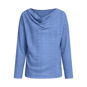 Detail of the cowl neck and intricate hollow embroidery on the blue long sleeve top