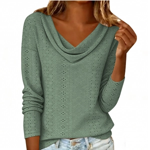 Detail of green long sleeve knit top showing the hollow pointelle texture and v-neckline