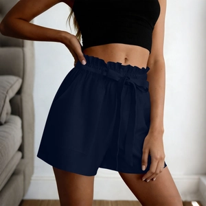 Detail of paperbag high waist with adjustable tie and pleated edges on navy blue shorts