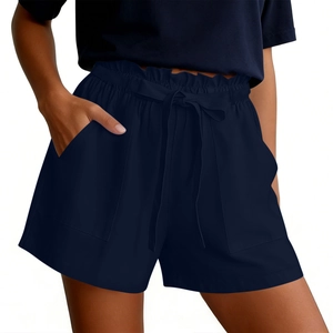 Detail of navy blue high-waisted shorts with elastic drawstring and side pockets