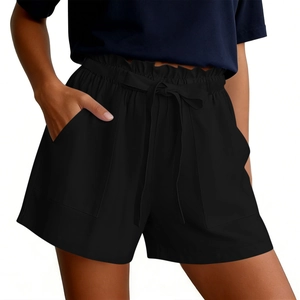Detail of high waisted black linen shorts featuring paperbag waist and drawstring bow