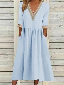 Light blue V-neck midi dress in cotton linen with white lace trim and practical side pockets