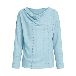 Detail of light blue long sleeve top featuring draped v-neckline and eyelet texture fabric