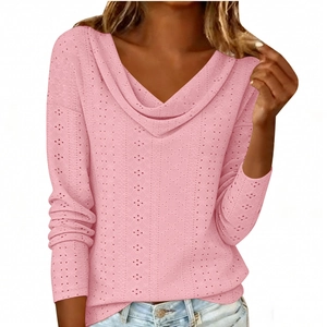 Detail of pink long sleeve top featuring a draped neckline and delicate eyelet fabric
