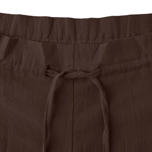 Detail of high-waist elastic waistband with drawstring on brown cotton linen wide leg pants