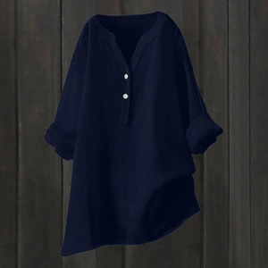 Detail of navy blue cotton linen V-neck blouse with white buttons and irregular hem