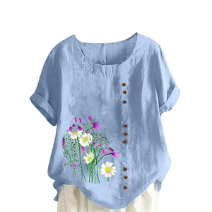 Detail of light blue linen shirt featuring white daisy print and brown button accents