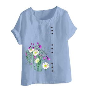 Detail of short sleeve cotton linen shirt with floral daisy print and dark buttons