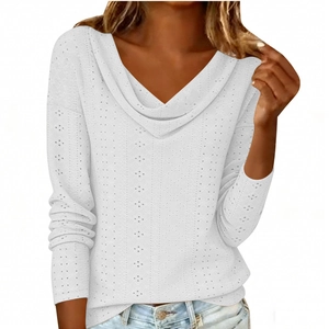 Detail of white long sleeve top featuring intricate eyelet pointelle and cowl neck design