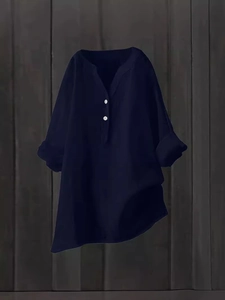 Women's casual navy blue cotton linen V-neck shirt with button details on a wood surface